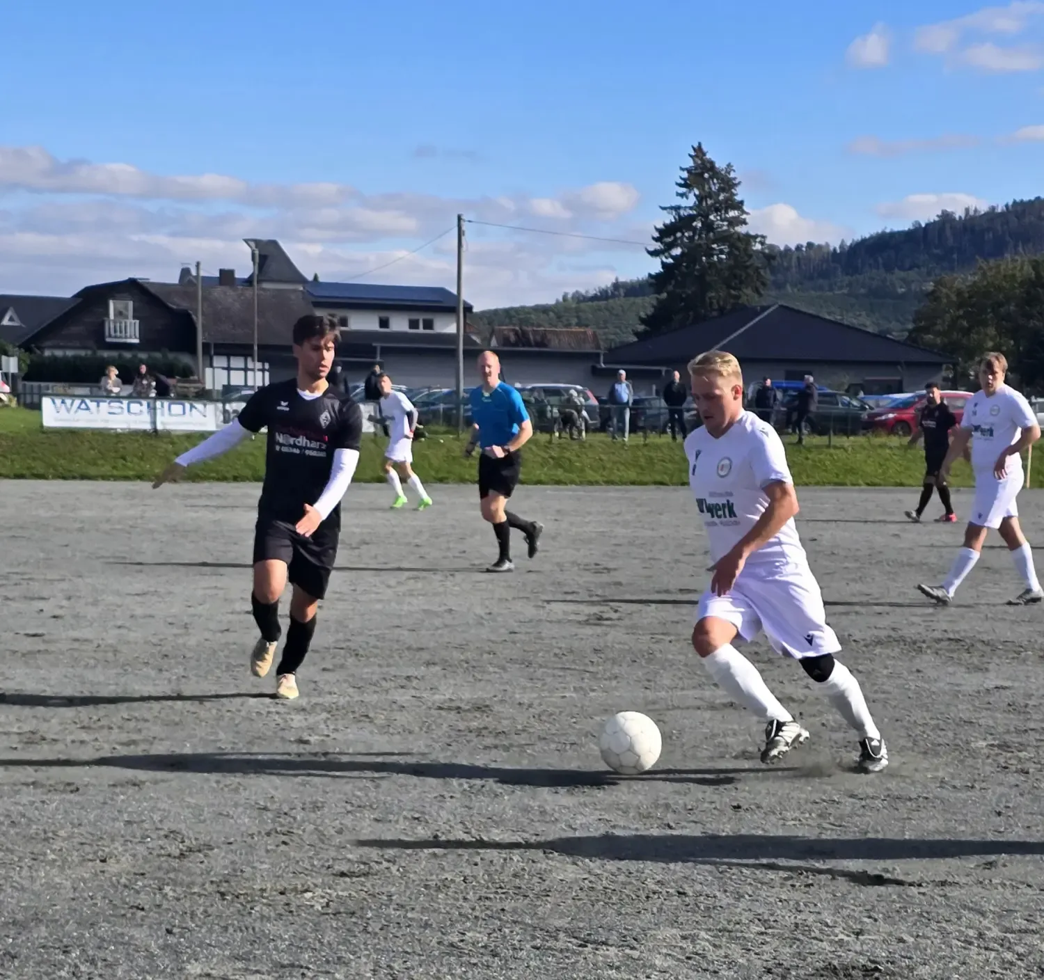 Fußballspiel des MTV Astfeld auf dem Sportplatz in Astfeld, Spieler in weißen und schwarzen Trikots.